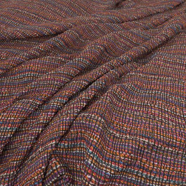 Plum and rust woven fabric with blue flecks and rippling textured lines