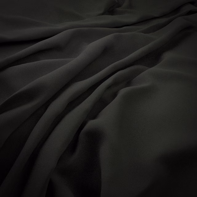 Near-black midnight-blue fabric with smooth folds and a subtle lustrous sheen