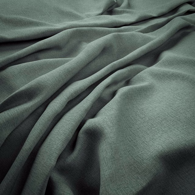 Close-up of muted sea-green woven fabric falling in soft, shadowed folds