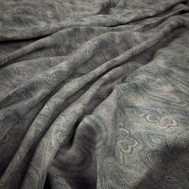Charcoal-grey paisley textile with blue-green tracery and softly rippled woven texture