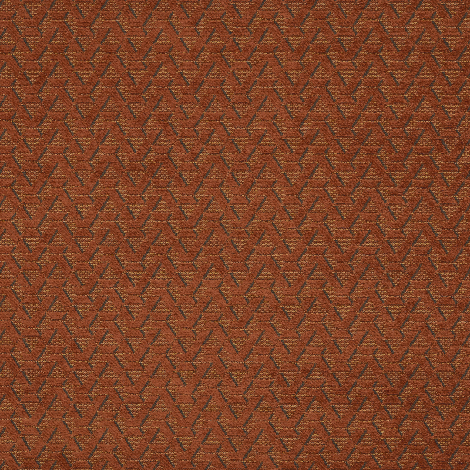 Burnt orange geometric woven fabric with small zigzag pattern and dark contrast threads
