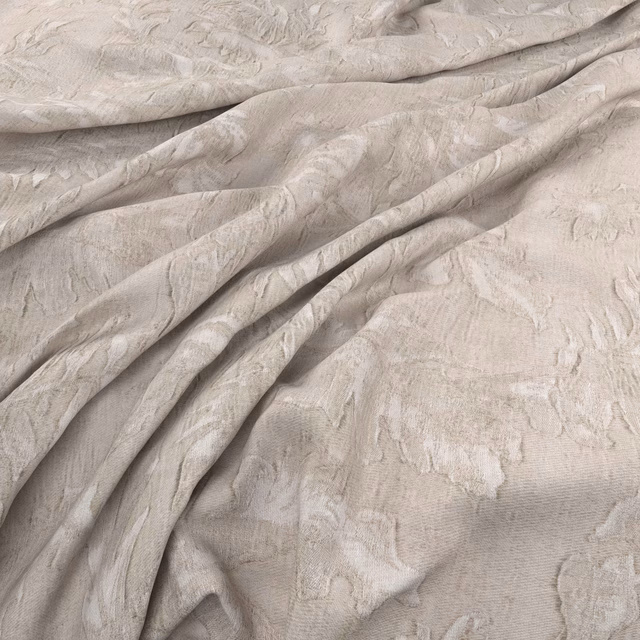 Pale greige Samani fabric with raised organic brush motifs in soft folds