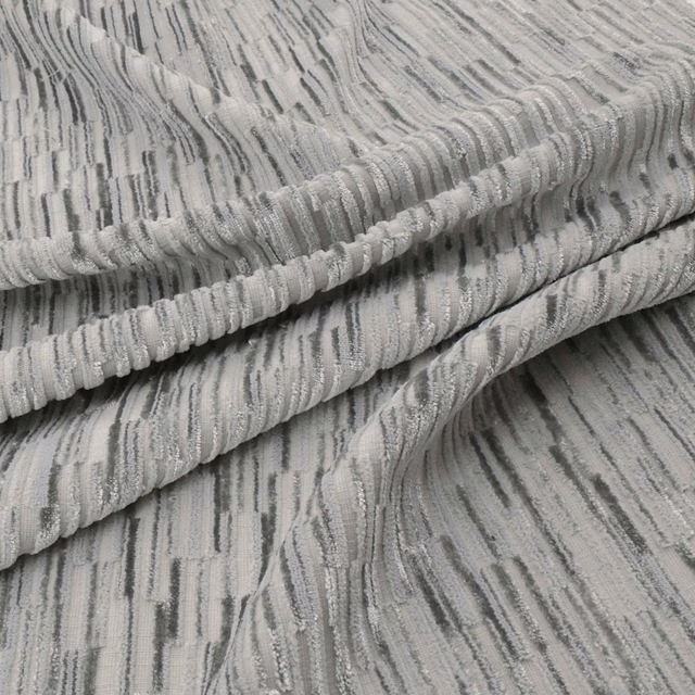 Cool basalt-grey fabric with raised ribs and irregular charcoal vertical striations