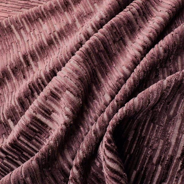 Close-up of plum Cordovan fabric with raised ribs and dark vertical striations