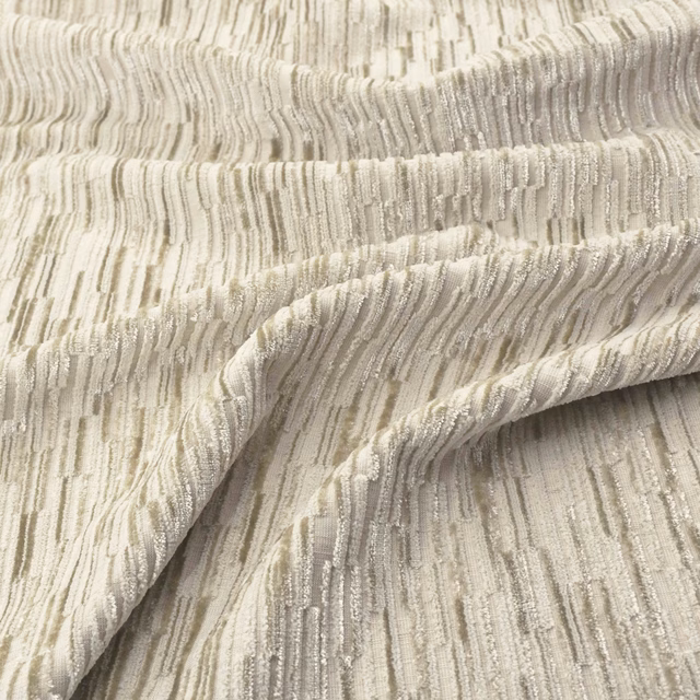 Warm sandstone beige woven fabric with irregular vertical striations and softly folded texture