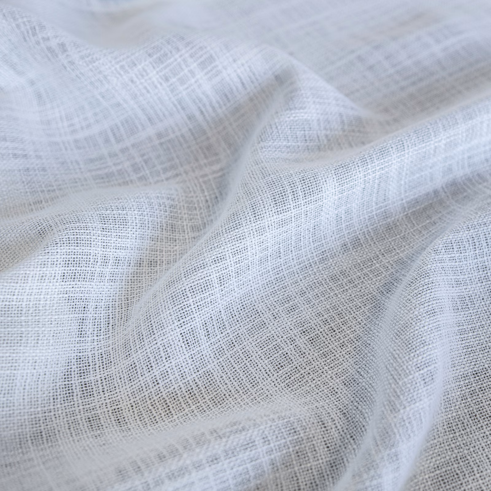 Pale blue-white Santorini fabric with fine open crosshatch weave in soft folds