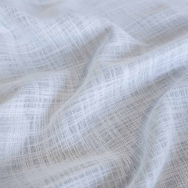 Pale blue-white Santorini fabric with fine open crosshatch weave in soft folds