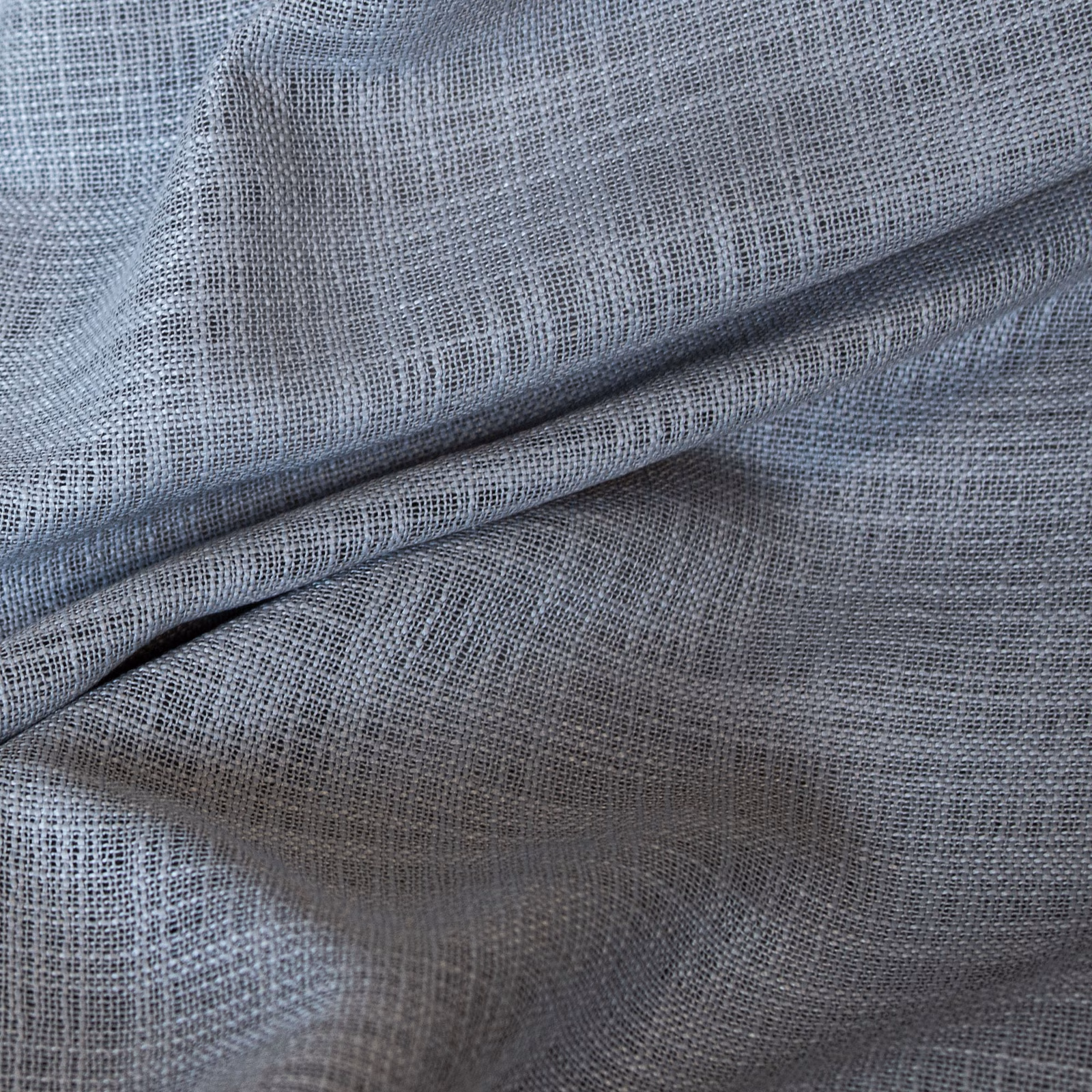Cool pebble-grey open-weave fabric folded to show gauzy texture and taupe-grey shadows
