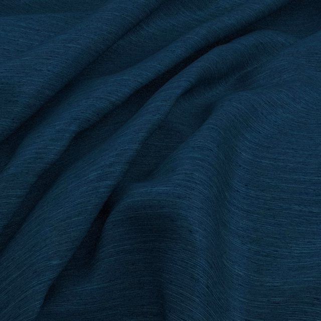 Deep cobalt-blue fabric with fine striations falling into soft, fluid folds