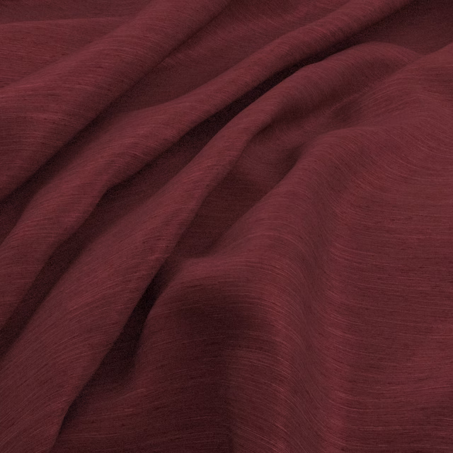 Deep grape-plum fabric draped in folds with fine horizontal slub texture