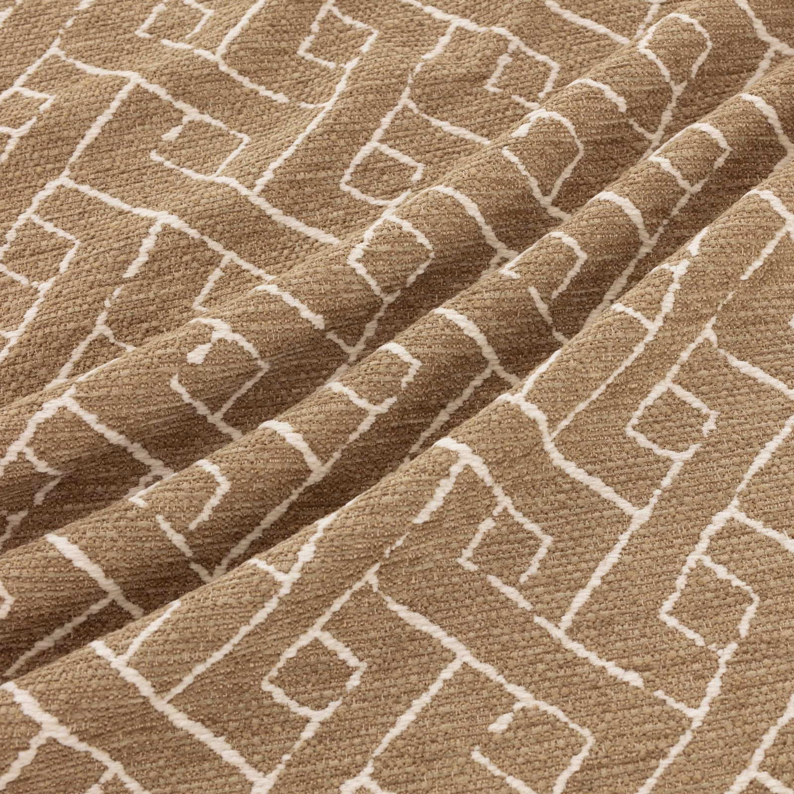 Warm taupe woven fabric with cream irregular diamonds and raised textured folds