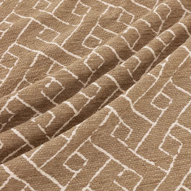 Warm taupe woven fabric with cream irregular diamonds and raised textured folds