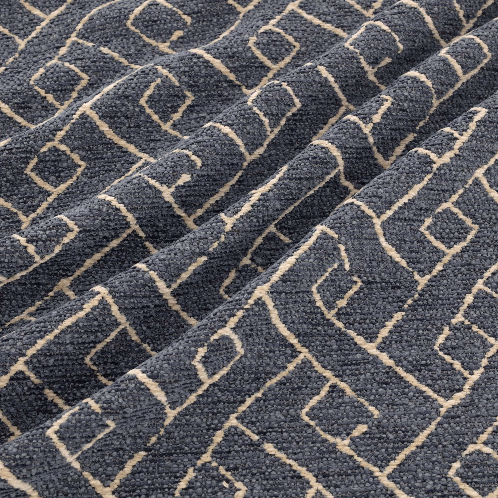Charcoal-grey nubby weave with warm beige angular diamond motifs