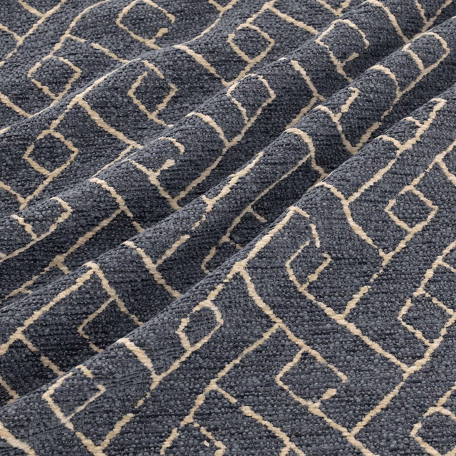 Charcoal-grey nubby weave with warm beige angular diamond motifs