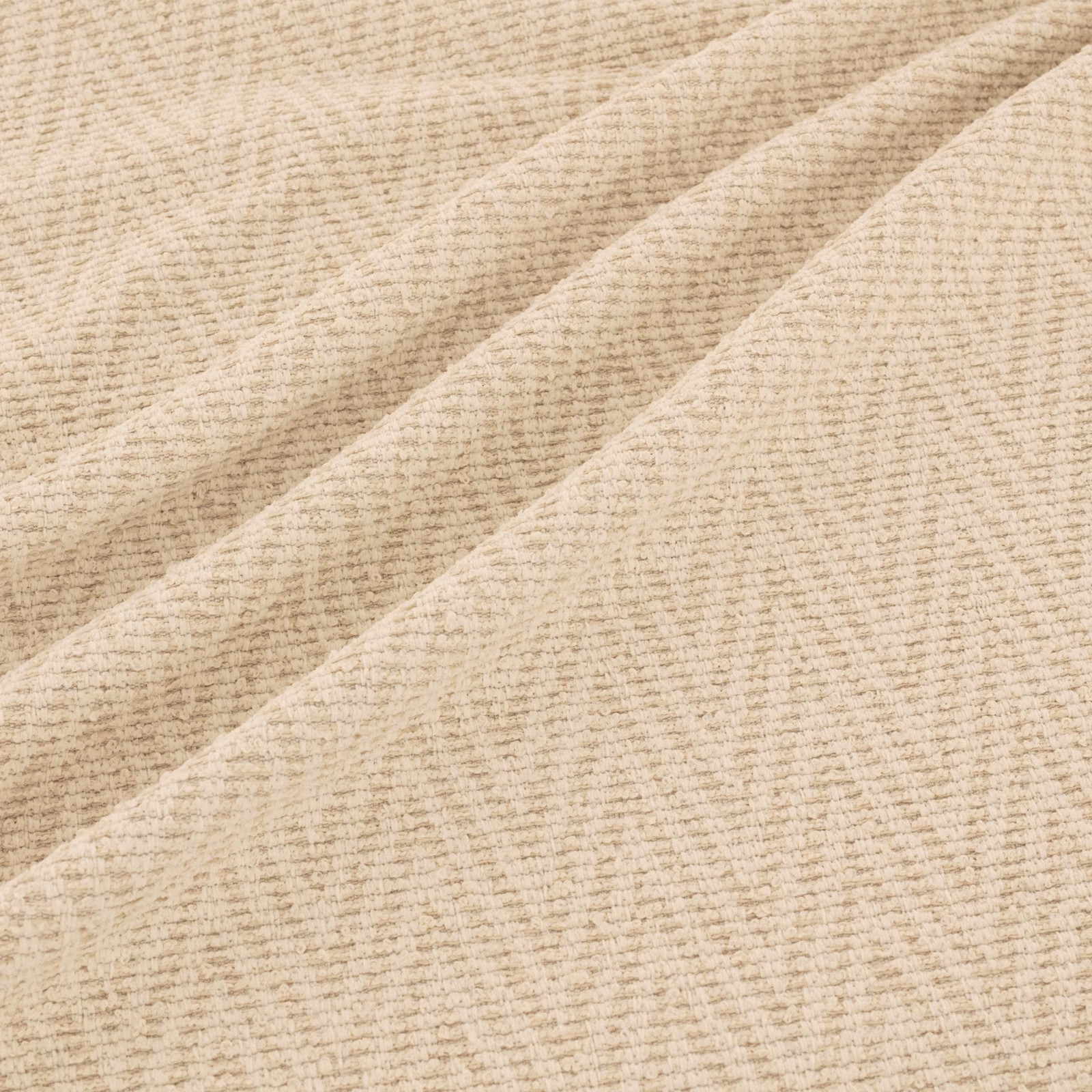 Pale oat-beige ribbed fabric swatch folded to show its softly textured weave