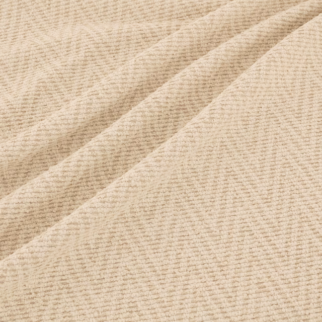 Pale oat-beige ribbed fabric swatch folded to show its softly textured weave