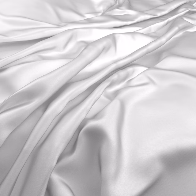 Cool icy-white fabric with smooth satin-like highlights folding into soft ripples