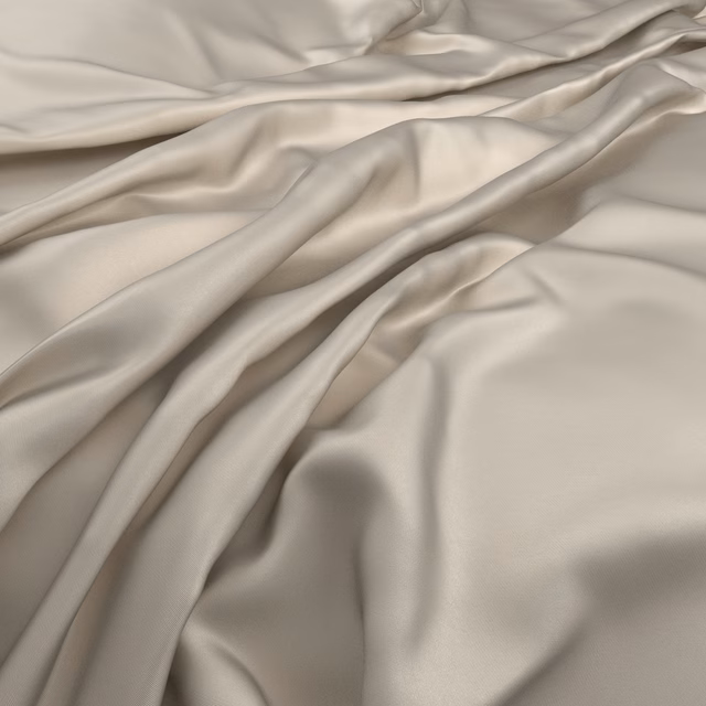 Warm champagne-cream fabric in smooth fluid folds with softly lustrous highlights