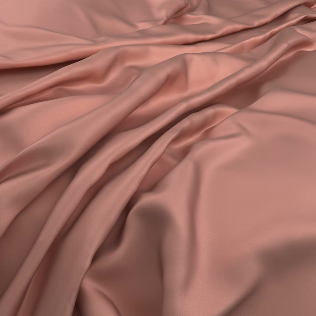 Dusty coral-pink cloth falling in softly lustrous, fluid folds