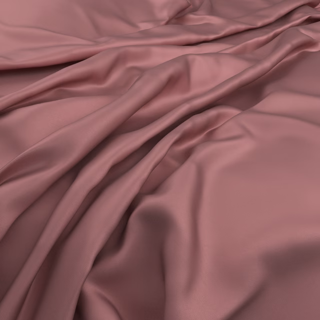 Close view of dusty rose fabric falling in softly lustrous, fluid folds
