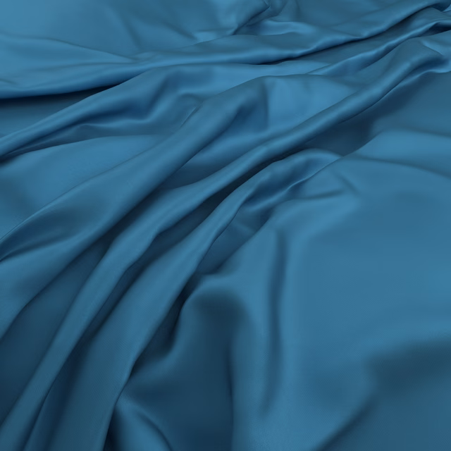 Saturated electric-blue fabric gathered in fluid folds with dark and bright shading