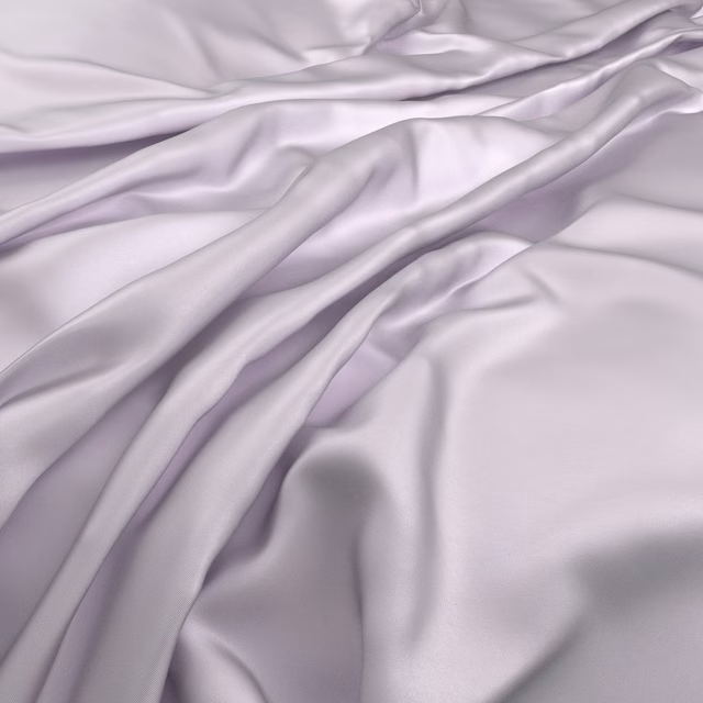 Pale lilac-purple fabric draped in fluid folds with a soft, silky sheen