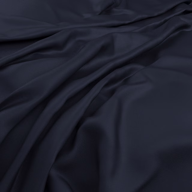 Deep midnight-blue fabric falling in smooth, softly lustrous folds