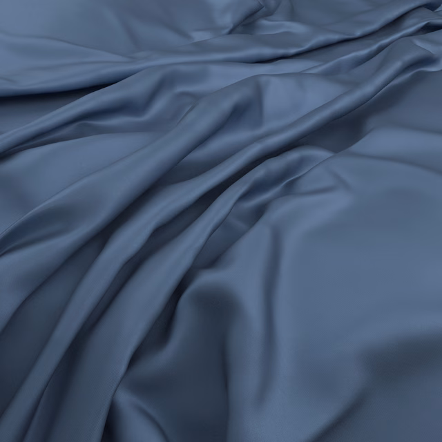 Cool blue-grey fabric in gathered folds, showing smooth sheen and deep shadows