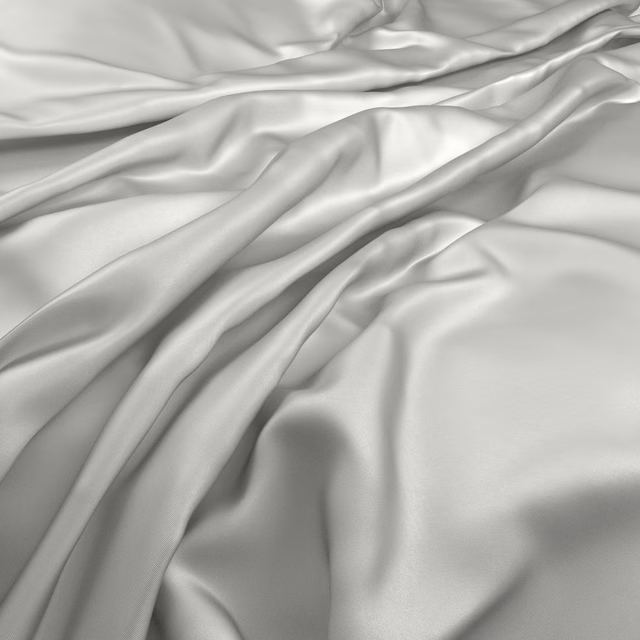 Pale platinum-grey fabric arranged in smooth, lustrous flowing folds