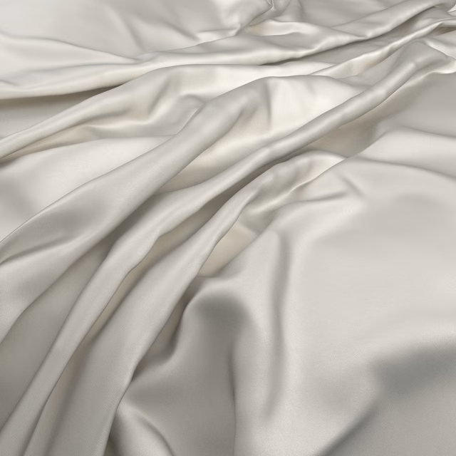 Pale ivory satin-like cloth gathered into fluid, reflective folds
