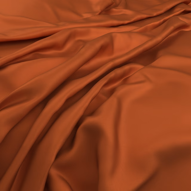 Warm rust-orange Serena Tiger fabric arranged in smooth, glossy flowing folds