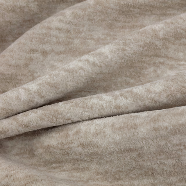 Warm oyster-beige Sherpa textile with mottled short pile folded into soft ridges