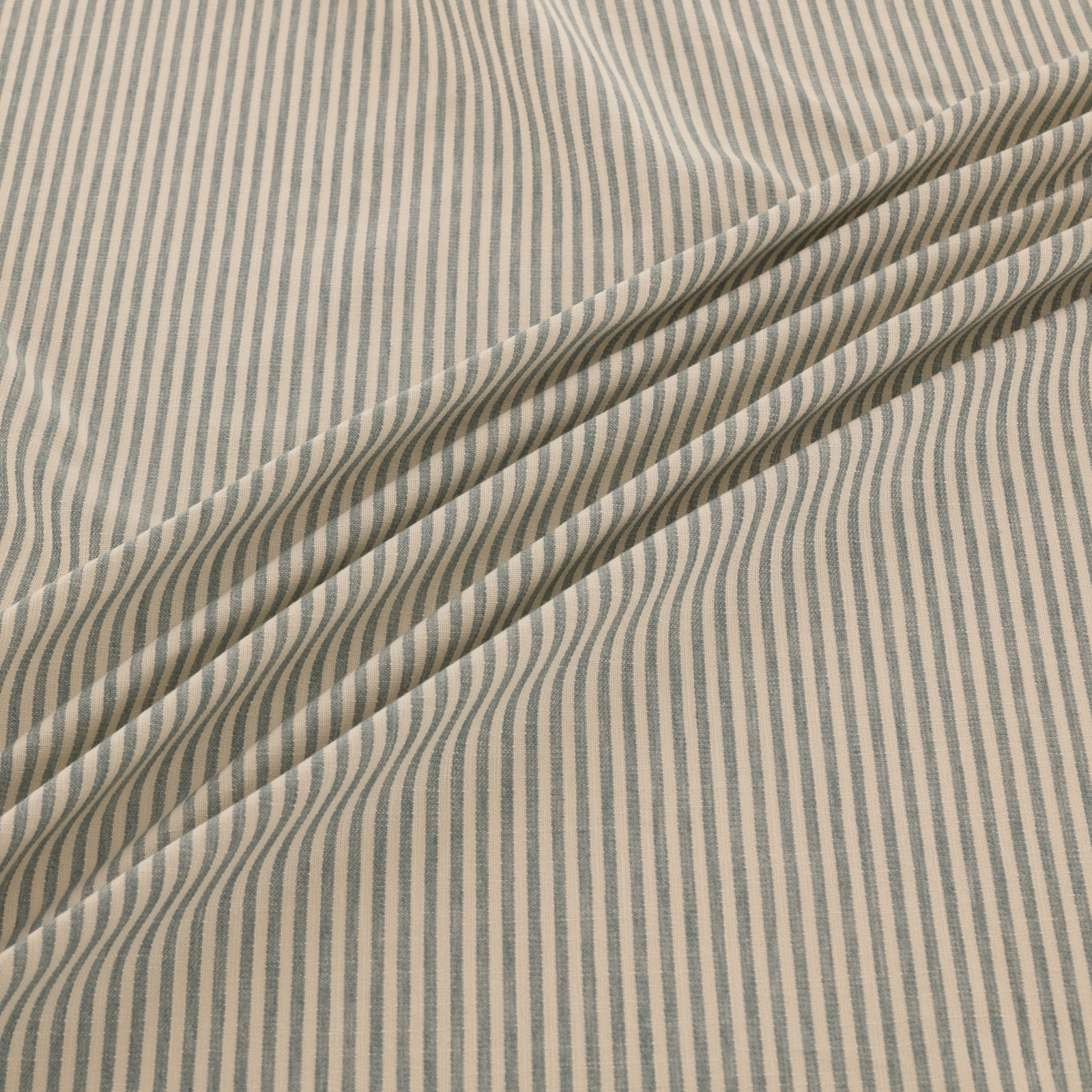 Blue-grey irregular vertical stripes on an ivory woven fabric, folded into soft diagonal layers