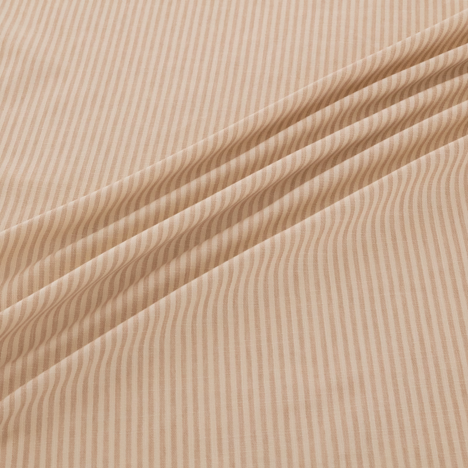Warm shell-beige fabric with fine undulating stripes arranged in soft flowing folds