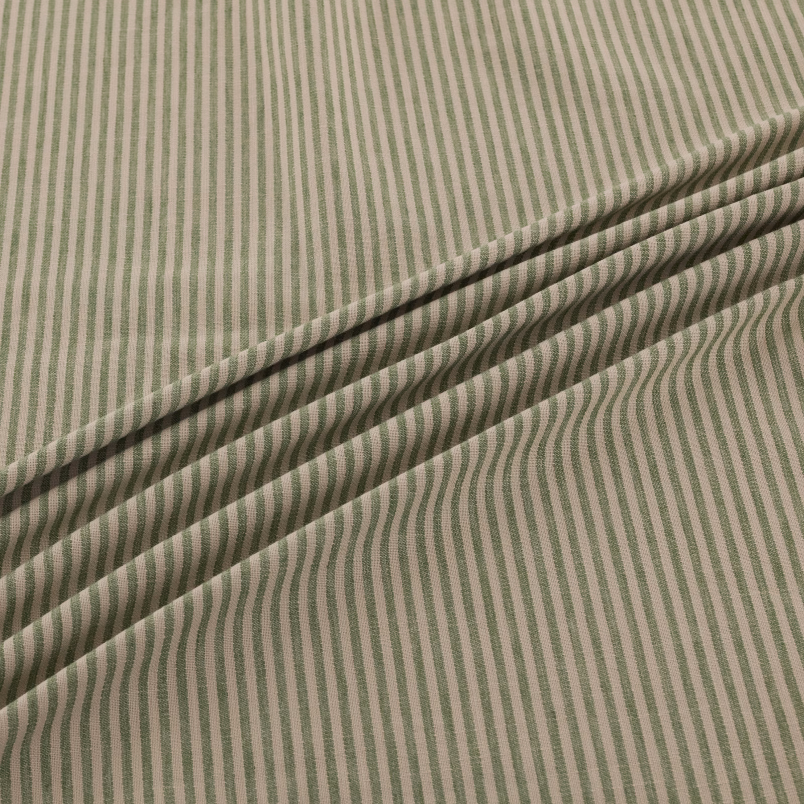 Muted sage and cream fabric with fine, gently undulating vertical stripes across folded cloth