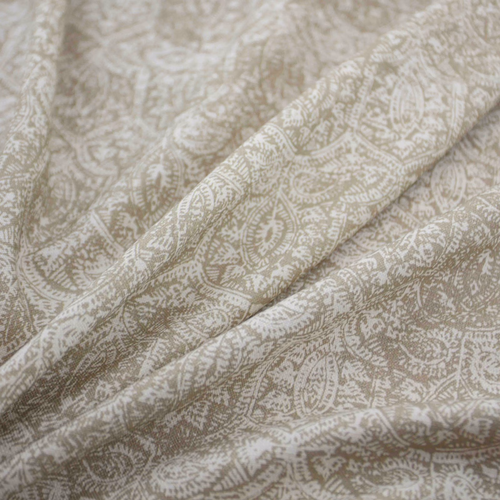 Warm putty taupe textile with ivory paisley and leafy motifs in soft folds