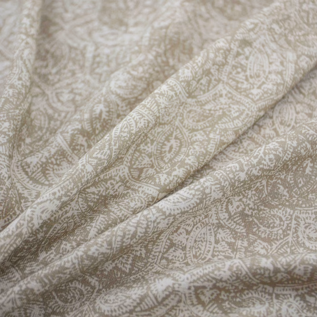 Warm putty taupe textile with ivory paisley and leafy motifs in soft folds