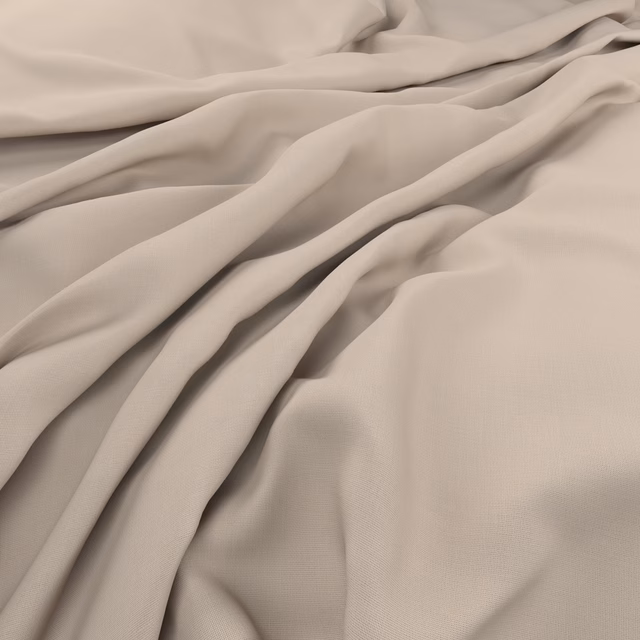 Warm coconut-cream fabric close-up showing fine weave and soft fluid folds