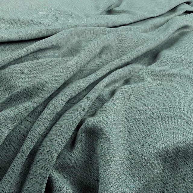 Muted turquoise woven fabric gathered into soft, shadowed folds