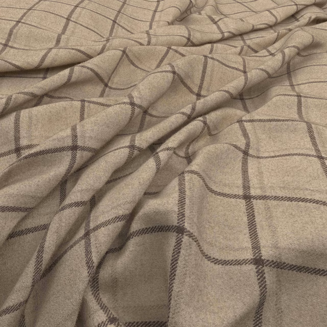 Ecru woven fabric with an irregular taupe windowpane check and soft folds