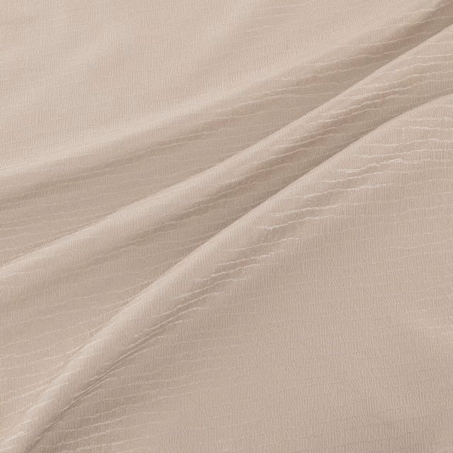 Pale quartz-taupe fabric with fine rippled lines falling in soft fluid folds