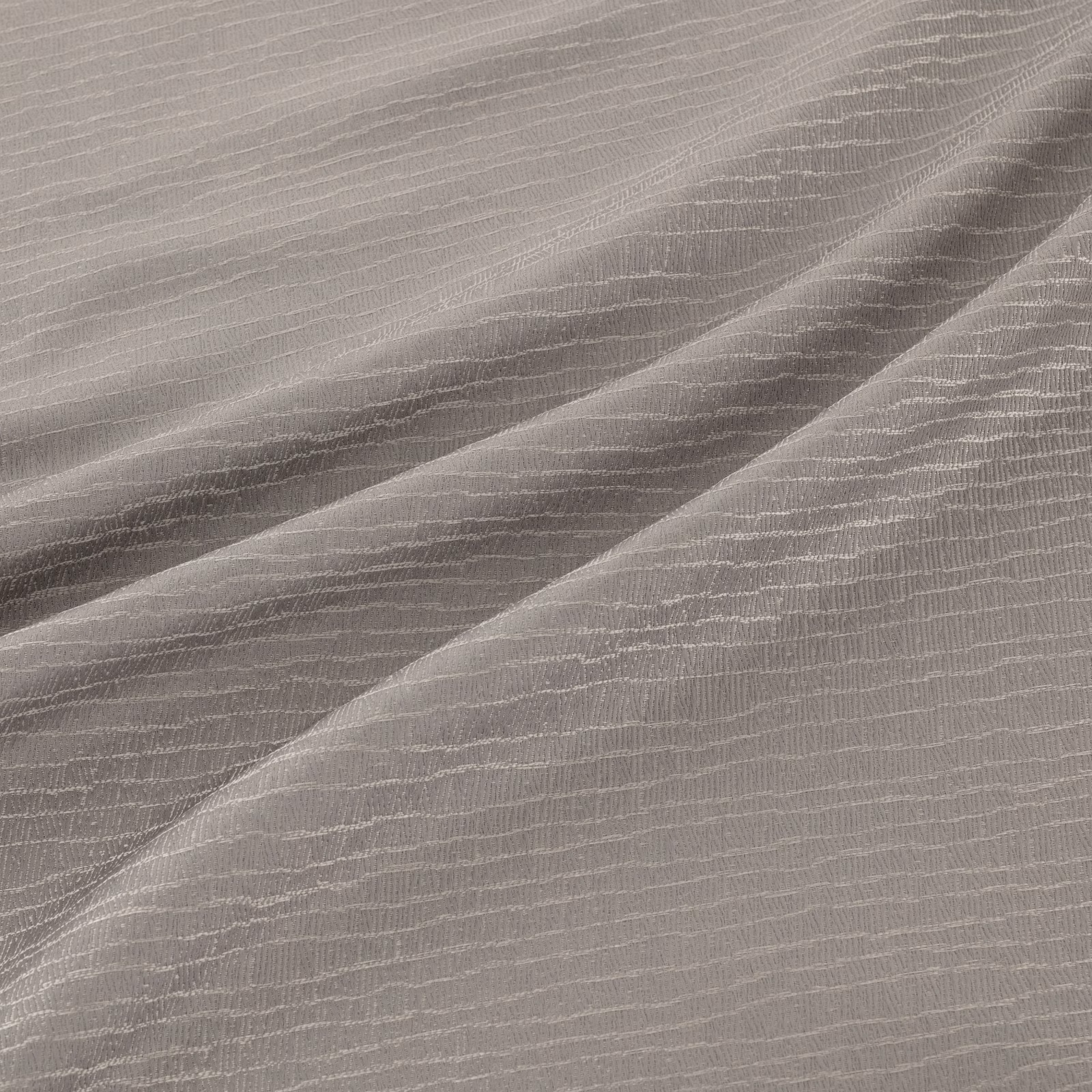 Cool silver-grey fabric with fine rippled lines and diagonal shaded folds