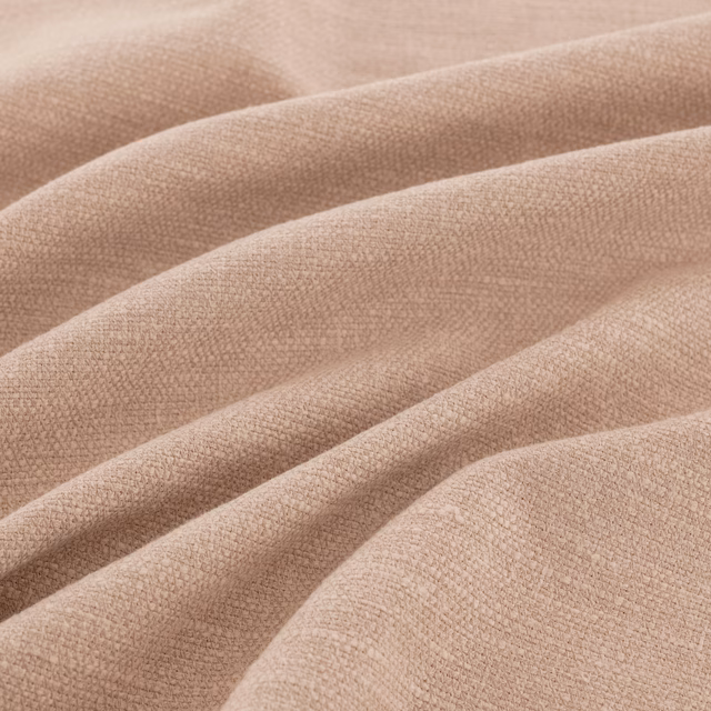 Close view of dusty blush-pink fine weave forming soft diagonal folds