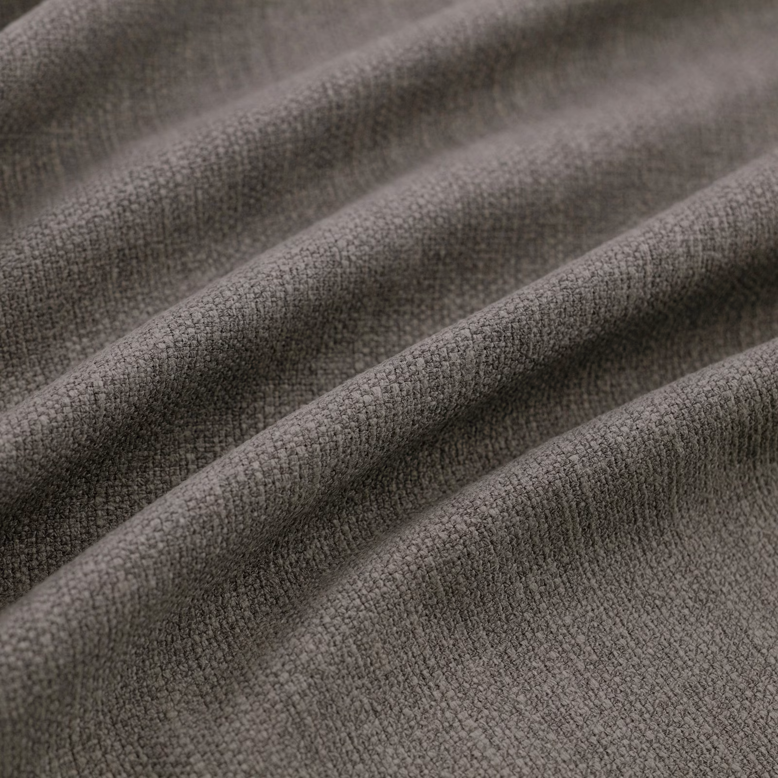Deep charcoal-grey woven fabric with fine pebbled texture folded into soft ridges