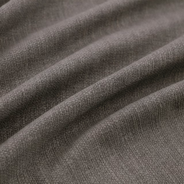 Deep charcoal-grey woven fabric with fine pebbled texture folded into soft ridges