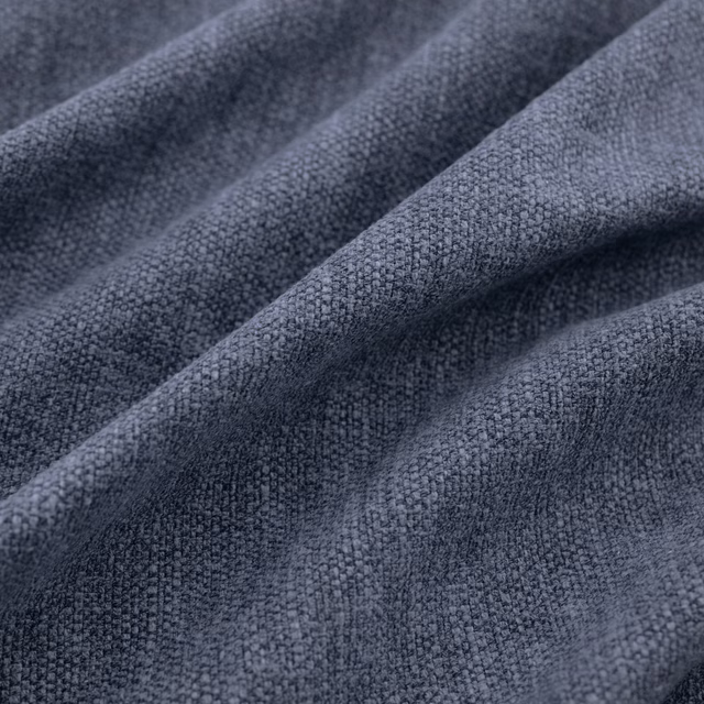 Close-up of dark indigo-blue woven cloth with nubby texture in soft folds