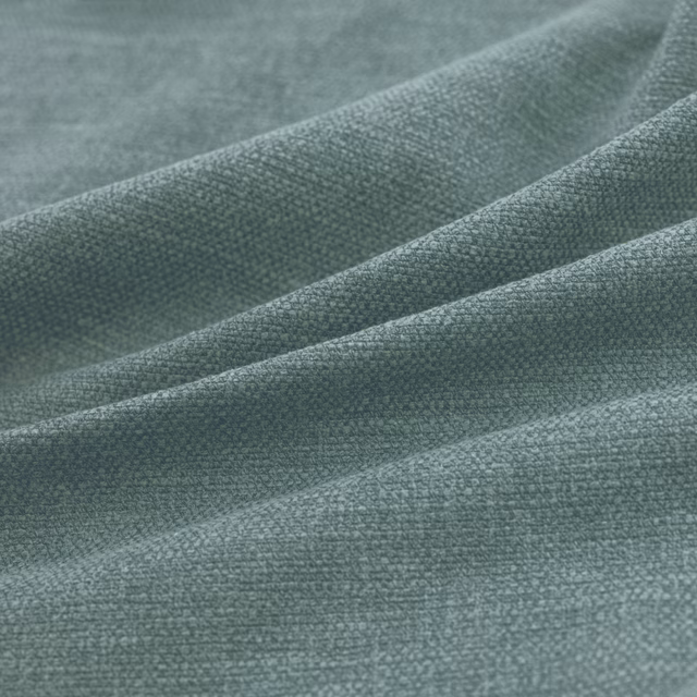 Muted kingfisher teal woven textile shown in soft folds with a fine grain