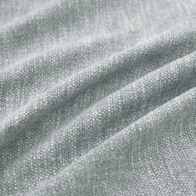Cool seaglass grey-green woven fabric with fine pebble texture in soft folds