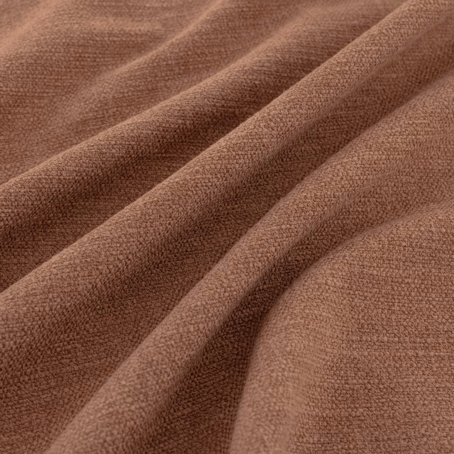 Warm Tuscan brown fabric with a softly nubby woven texture folded into ridges
