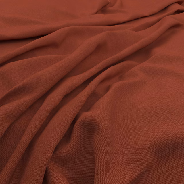 Warm cayenne terracotta linen-look weave gathered into soft, shadowed folds